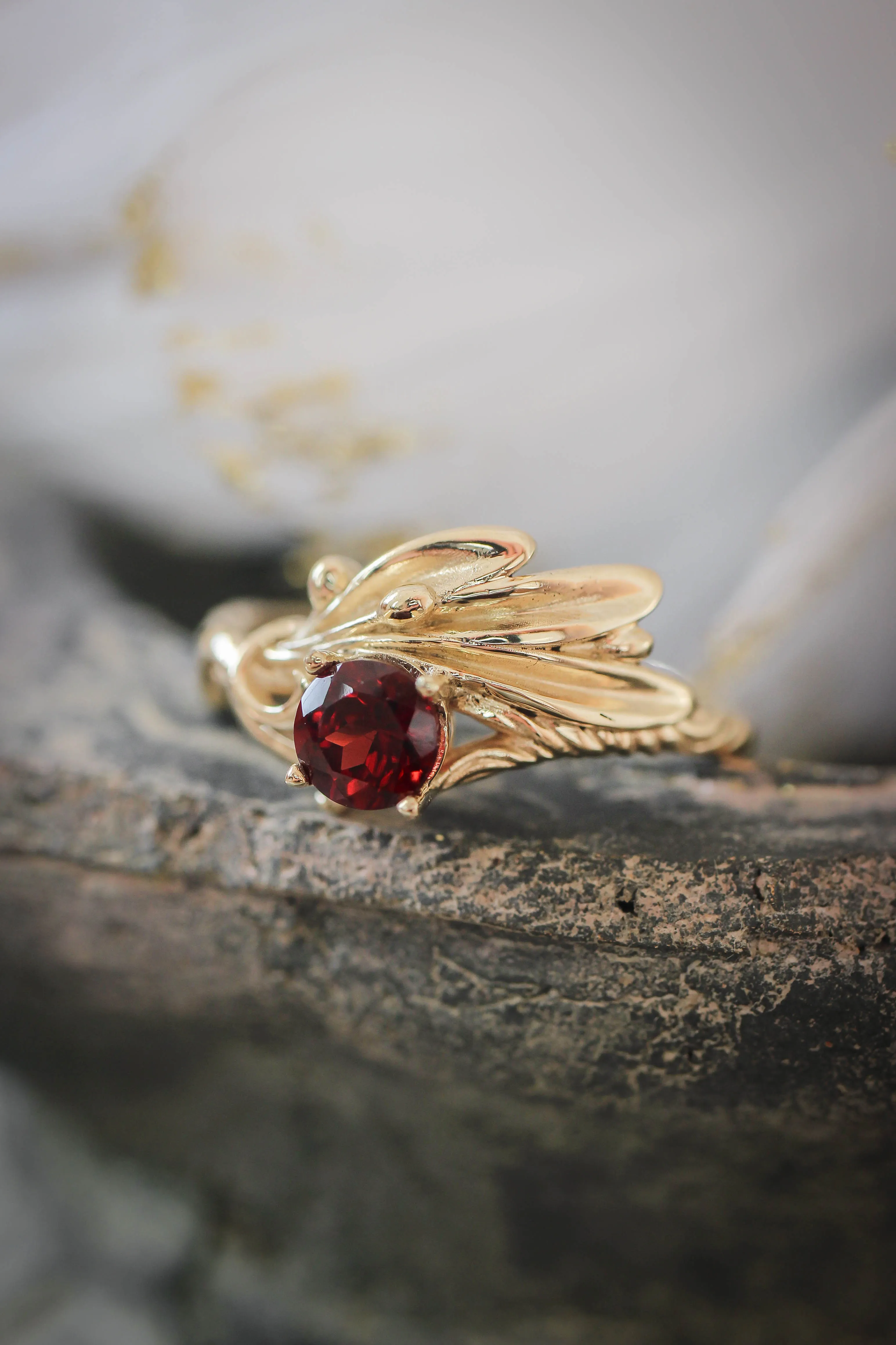 Olive branch ring with ribbon and red garnet