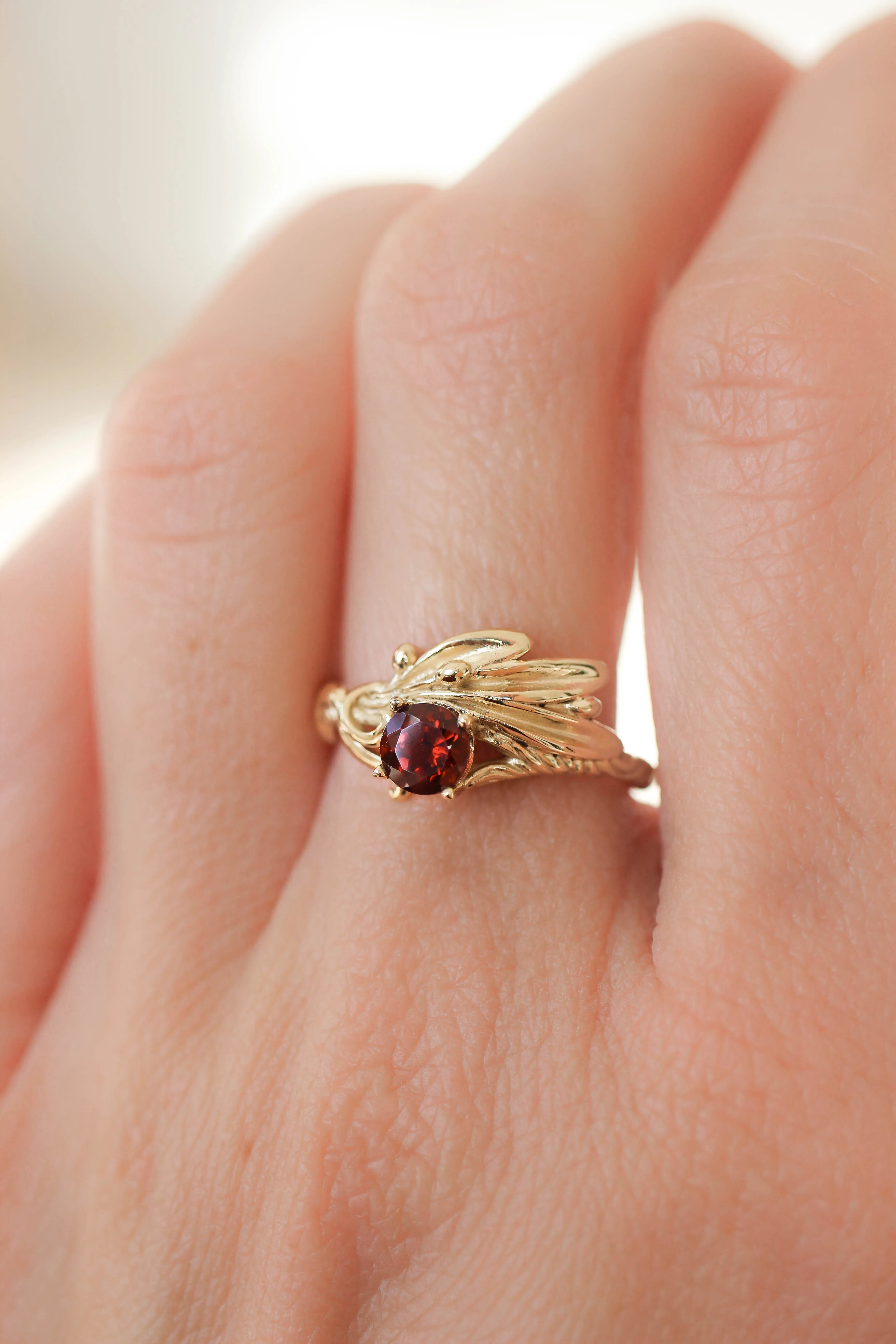 Olive branch ring with ribbon and red garnet