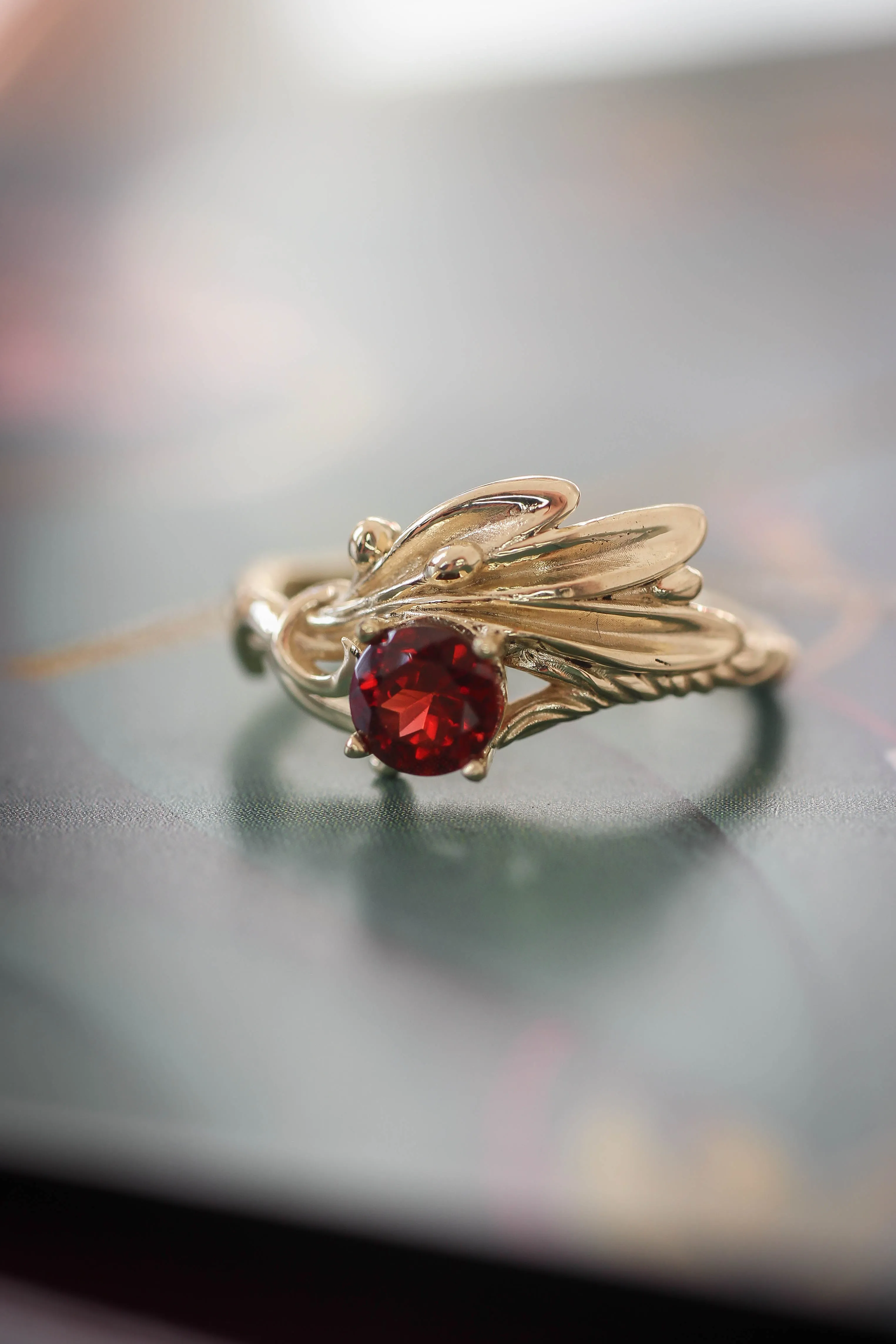 Olive branch ring with ribbon and red garnet