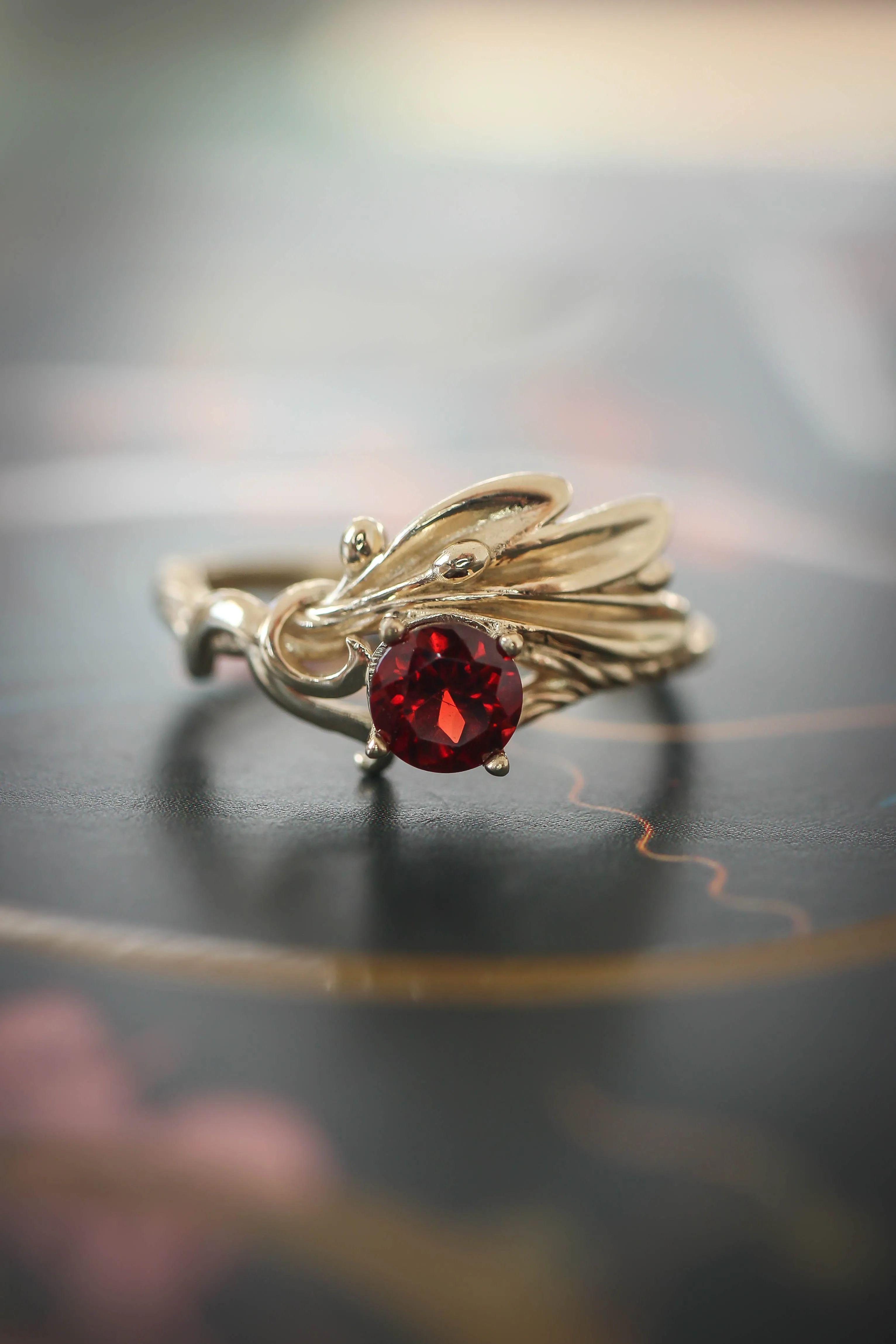 Olive branch ring with ribbon and red garnet