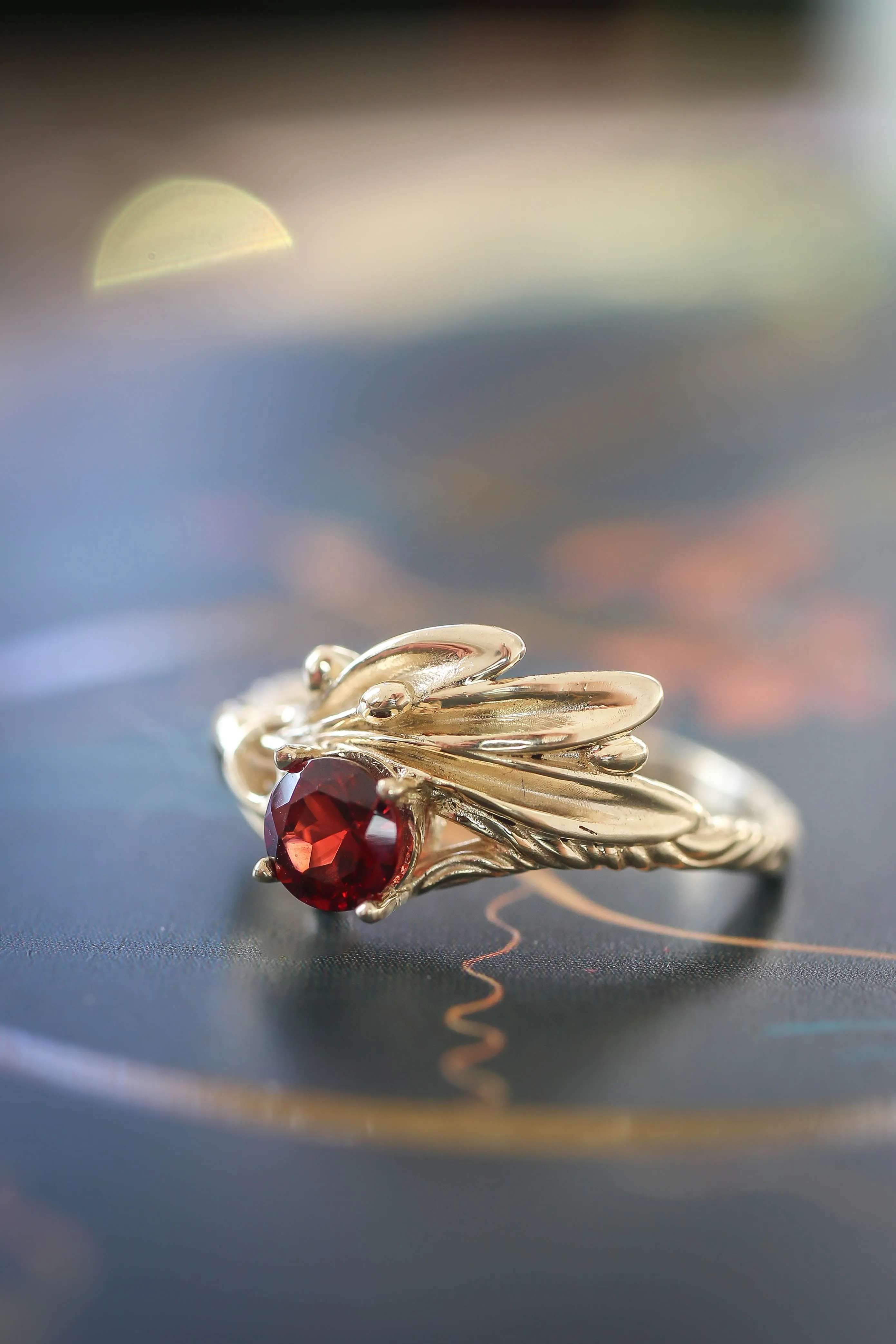 Olive branch ring with ribbon and red garnet